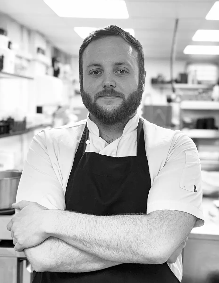 About Fletcher's Restaurant - Meet Andy, one of our talented chefs, smiling happily in our kitchen as she prepares delicious dishes for our guests.